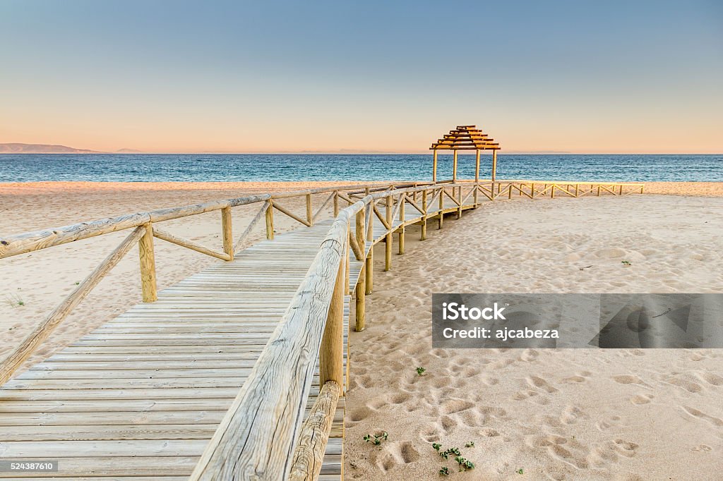 Wooden boardwalk to the beach. Idyllic scene Wooden boardwalk to the beach. Idyllic scene in Trafalgar coast, Cadiz, Spain. Cádiz Stock Photo