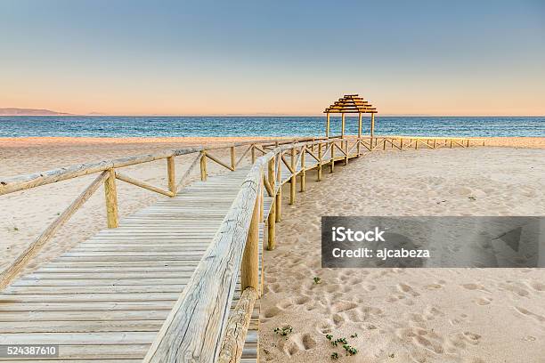 Wooden Boardwalk To The Beach Idyllic Scene Stock Photo - Download Image Now - Cádiz, Beach, Capital Cities