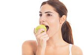 Beautiful young girl eating apple