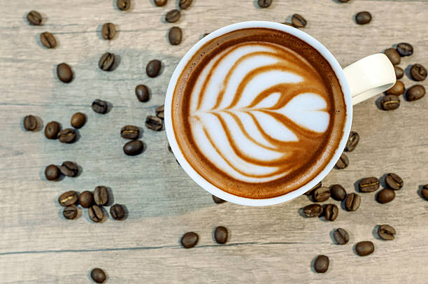 istock Cup of espresso with coffee beam on wooden kitchen table 524391424