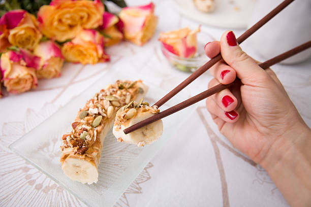 Banana sushi servered with nuts and granola