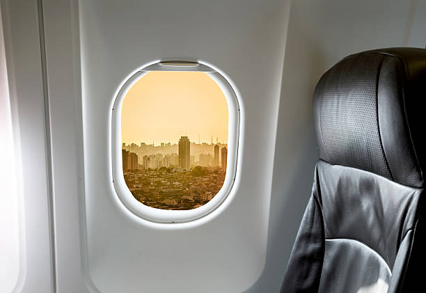 istock Buildings through aircraft window onto jet engine 524392634