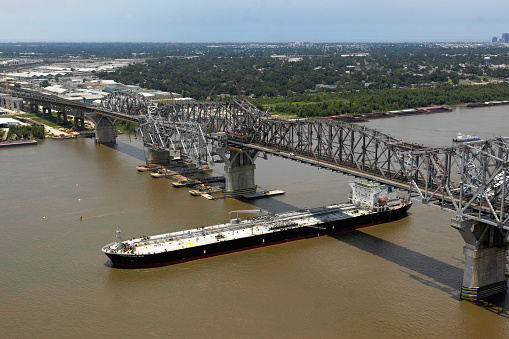 US 90 Huey P Long Bridge over the Mississippi River, New Orleans, Louisiana.  This is a photo during the widening of the Huey P Long Bridge with a barge passing underneath.