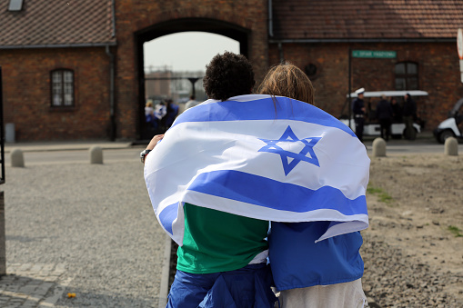 Auschwitz, Poland - April 16, 2015:   International Holocaust Remembrance Day . Annually people from the all the world meets on the March of the Living in german Concentration Camp in Auschwitz Birkenau. Poland