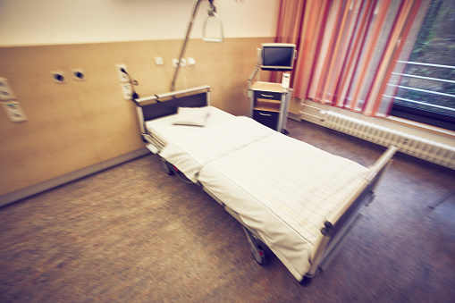 Interior shot of a hospital room with a hospital bed, a chair and other medical equipment. The hospital is in Newcastle Upon Tyne.