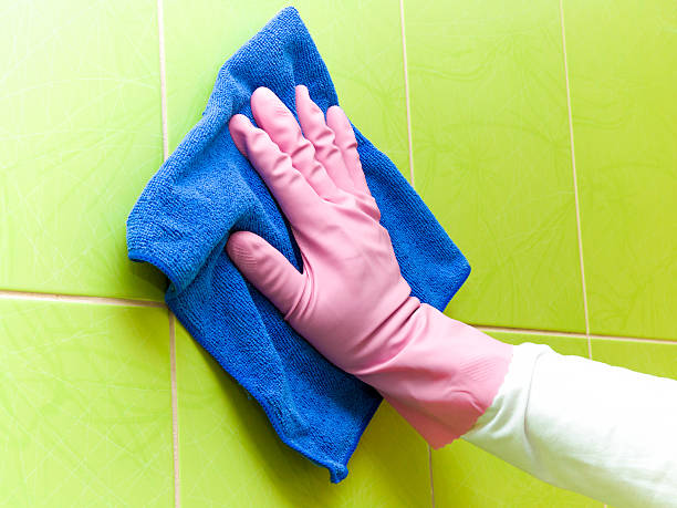 istock Maid cleans tiles with blue rag. Early spring cleaning. 524395162