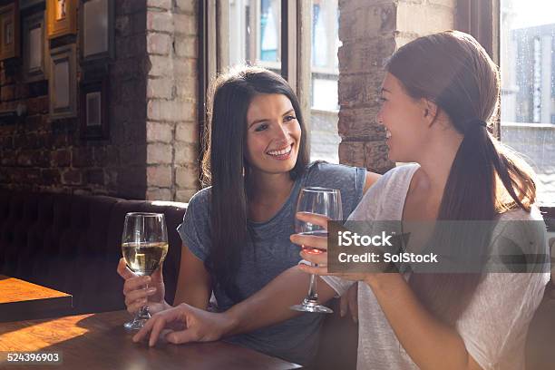 Two Women Enjoying A Drink Together Stock Photo - Download Image Now - Wine, Pub, Only Women