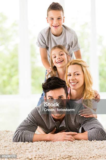 Happy Family Of Four Stock Photo - Download Image Now - Adult, Bedroom, Boys