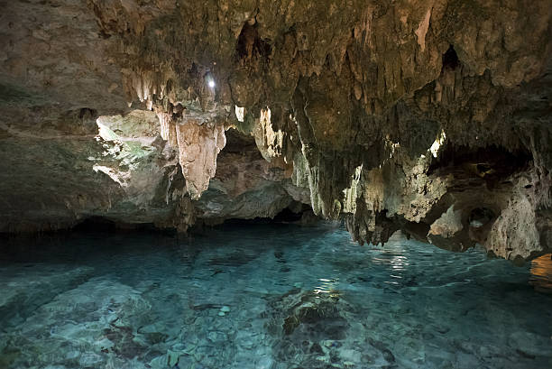 istock Inside of stone cave with blue water and rocks 524397240