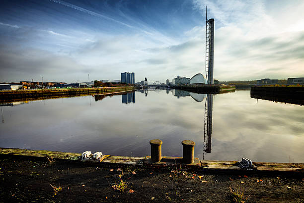 The Derelict Graving Docks at Govan, Glasgow A rusting iron cleat at the derelict Victorian graving docks - a type of dry dock - in Govan, Glasgow, on the River Clyde. In the background is the modern Glasgow skyline. govan stock pictures, royalty-free photos & images