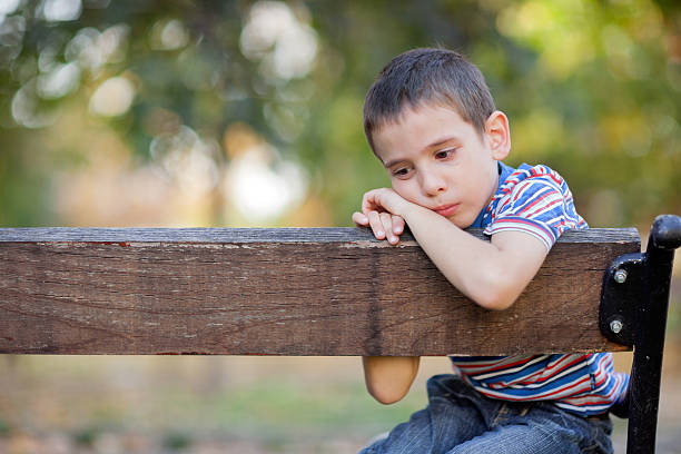 lonely young orphan in park crying