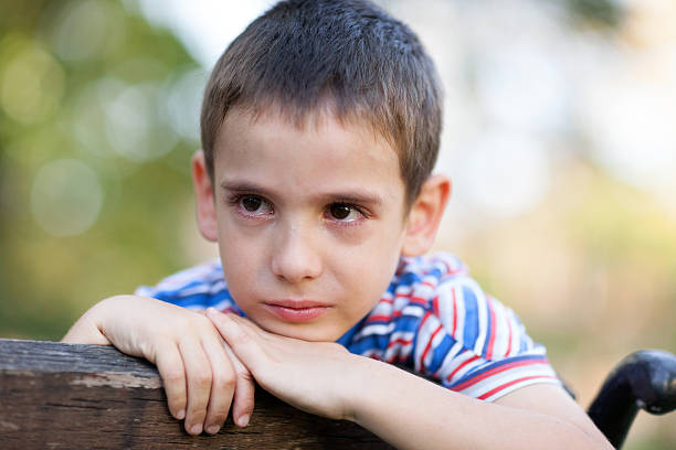 lonely young orphan in park crying