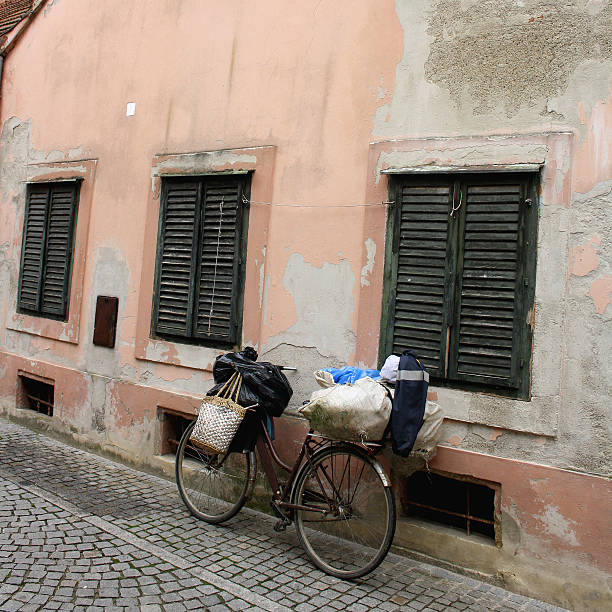 Vintage bike against the rustic pink wall on the streets of Varazdin, Croatia.