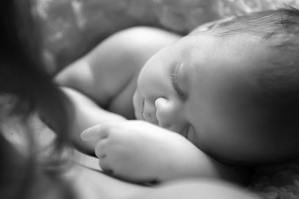 istock adorable baby sleeping on stomach 524399175