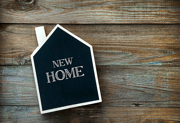 istock House Shaped Chalkboard sign on rustic wood NEW HOME 524399717