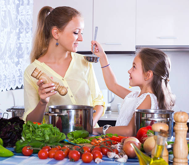 istock Girl helping mother to prepare 524400726