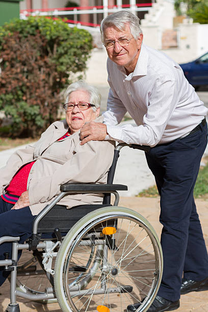 istock Man walking with senior woman 524403093