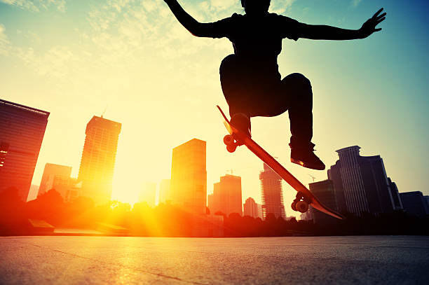 istock skateboarding woman jumping at  sunrise 524403437