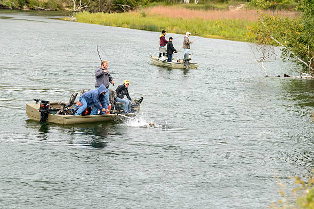 Aerial view of couple being guided on a drift boat fishing trip for salmon and steelhead in autumn, Washington State