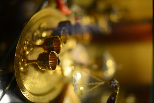 A closeup of a vintage watch leaned on a red book