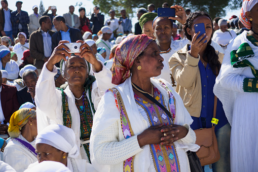 Jerusalem, Israel - November 20, 2014: Ethiopian Jewish women mix old tradition of prays, with modern documentation devices, at the Sigd, in Jerusalem, Israel. The Sigd is an annual holiday of the Ethiopian Jews
