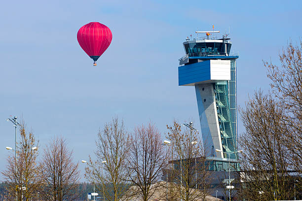 hot air balloon at airport tower - spy balloon stok fotoğraflar ve resimler