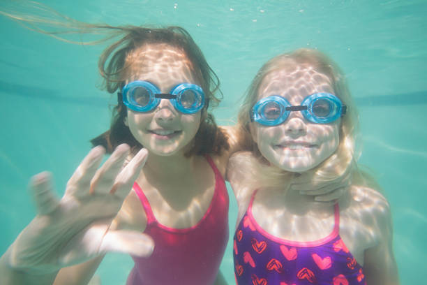 istock Cute kids posing underwater in pool 524426901