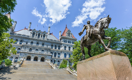 The New York State Capitol Building in Albany, home of the New York State Assembly. Monument of General Sherman on horseback.