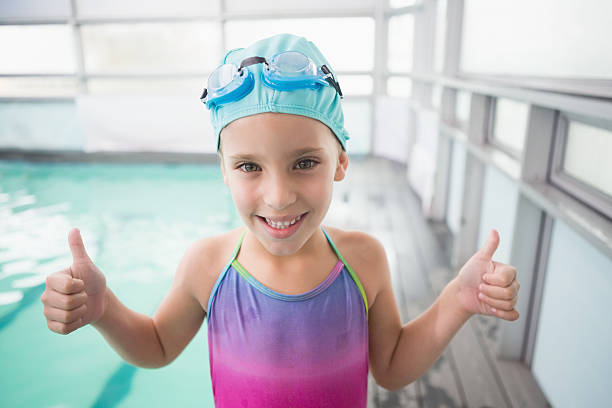 istock Cute little siblings sitting poolside 524428937