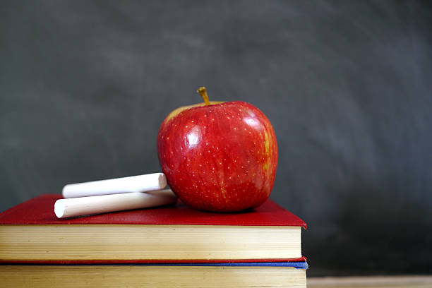 istock chalk and apple on pile of books 524452063