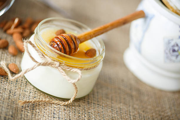 homemade yogurt with honey and nuts in a glass jar