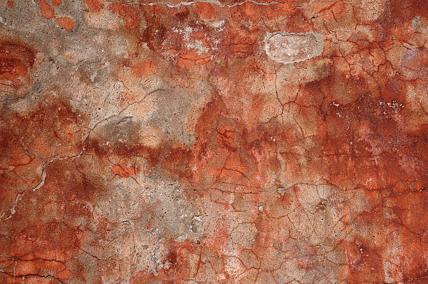 istock Texture of old wall covered with red stucco 524478601