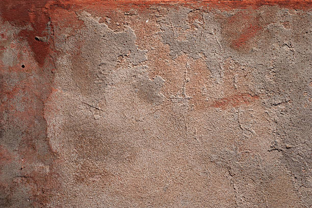 istock Texture of old wall covered with red stucco 524478605