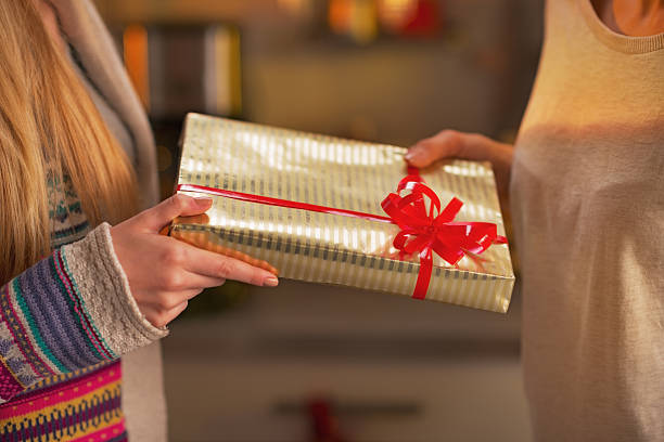 istock closeup on two girlfriends exchanging christmas presents 524509707