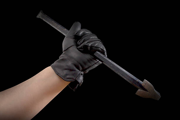 istock Hand in leather gloves holding jemmy 524509717