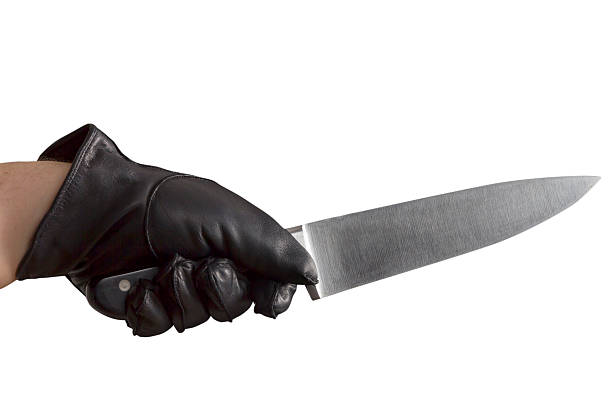 istock Hand in leather gloves holding knife 524509731