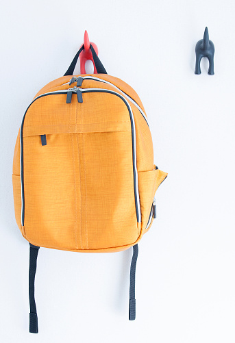 Orange backpack on the wall
