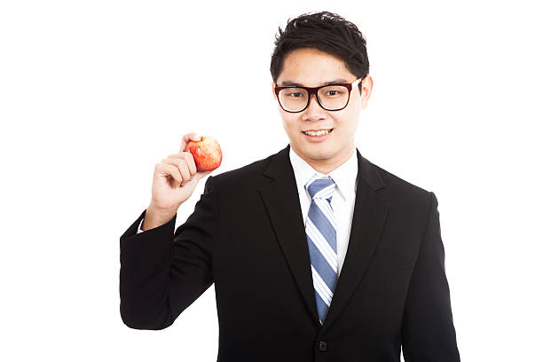 istock Healthy Asian businessman with red apple 524511973