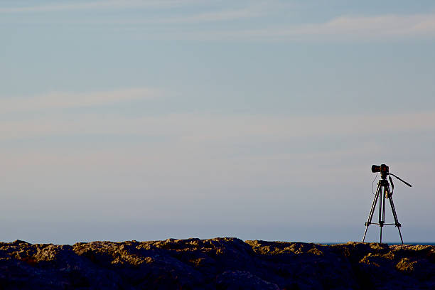 istock Digital camera on a tripod with sunset skies 524512087