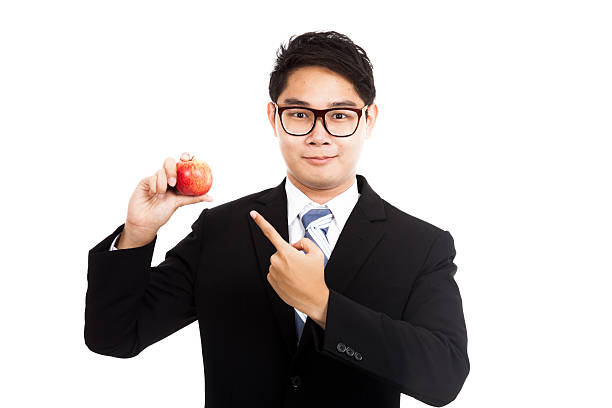 istock Healthy Asian businessman point to red apple 524513367