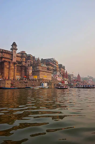 Varanasi, India . People praying on Ganges river ghats during Kumbh Mela festival in early morning