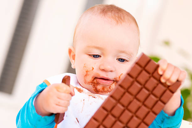 istock Baby boy eating chocolate 524527374