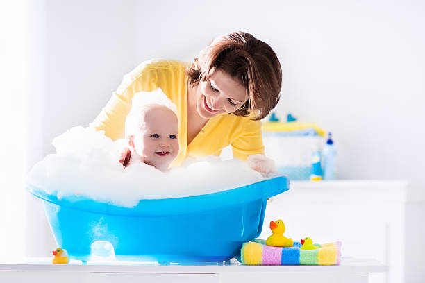 istock Young mother bathing baby boy 524529782