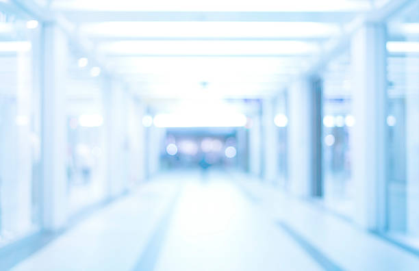 abstract blurred background with bokeh lights in blue tones medical blurred background, blurry empty hospital corridor in neon blue light, defocused airport passage place of research stock pictures, royalty-free photos & images