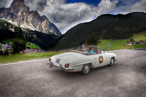 Corvara, Italy - July 24, 2015: historical  car and along the hairpin bends of Corvara in the Italian Dolomites during the race for historic cars Gold Cup