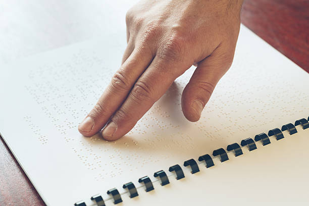 istock Visually impaired old person learning to reading by touch. 524531400