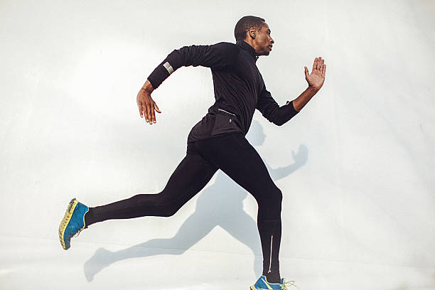 istock Young fit man running beside the white wall 524531708