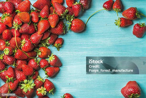 Strawberries Over Turquoise Blue Painted Wooden Background Stock Photo - Download Image Now