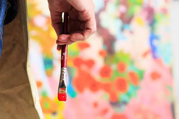 Photo of Fine art painer holding a paintbrush