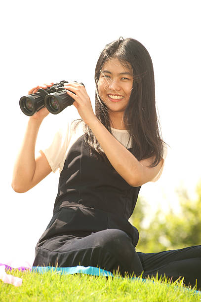 istock Pretty Asian woman sit on mound seeking Binoculars . 524534472